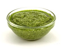 Pesto, a Ligurian sauce made out of basil, olive oil, hard cheese and pine nuts, and which can be eaten with pasta or other dishes such as soup BasilPesto.JPG