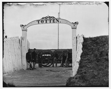 Men and gun of 3rd Massachusetts Heavy Artillery at ornamental gate of Fort Totten