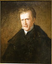 Color oil painting of the bust of a young white man with light brown short wavy hair and a plain countenance, looking at the viewer. The raised color of a white shirt is visible beneath a dark jacket and cloak. He stands before a plain brown-green background.