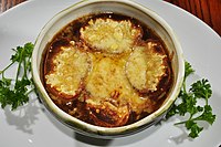 Cheese-covered croutons in an onion soup.