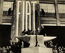 Mussolini in 1932, giving a speech at the Fiat Lingotto factory in Turin Mussolini visiting Fiat, 1932.jpg