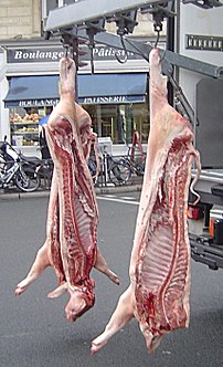 Three halves of pork being delivered
