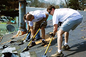 Workers using special "roofing shovels&qu...