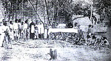 Spanish missionaries baptising a Moro convert in the Spanish East Indies, circa 1890. Two Spanish missionaries baptise a Moro convert to Roman Catholic, circa 1890.jpg