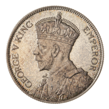 A crowned portrait of George V in royal dress, with the encircling text GEORGE V KING to the left, and EMPEROR to the right.