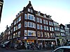 woon- en winkelpand historiserende architectuur met invloeden van Amsterdamse School