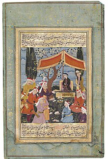 A seated Tamasp under a modest tent, with other people