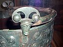 Aylesford bucket, Eimer aus Aylesford, 1. Jahrhundert vor Christus, zwei Gesichtsmasken als Attaschen mit Innenösen zur Aufnahme des Henkels.