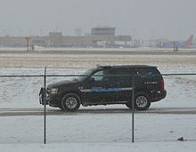 A Cleveland Hopkins International Airport Police officer patrols the airport perimeter in a Chevy Tahoe Police Cruiser. CLE Airport Police on Patrol.jpg