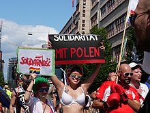 Marcher in 2019 Christopher Street Day 2019 march holding up Solidarity sign with Poland, following Bialystok attack Christopher Street Day Berlin 2019 27.jpg