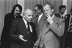 Prime Minister Joop den Uyl and former Chancellor of West Germany Willy Brandt at a Party of European Socialists conference in the Hague on 1 November 1974 Conferentie van leiders sociaal-democratische partijen EEG-landen in Den Haag, Bestanddeelnr 927-5558.jpg