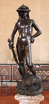 Bronze statue of a young naked man with helmet and sword