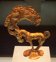 Gold stag with eagle's head, and ten more heads in the antlers. Inspired by Siberian Altai mountain art, possibly Pazyryk, unearthed at Nalinggaotu, Shenmu County, near Xi'an, China. Possibly from Huns of the Northern Chinese prairie. 4th to 3rd centuries BC, or Han Dynasty period. Shaanxi History Museum. Gold monster.jpg