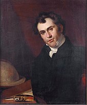 portrait of a man by a globe and desk
