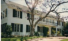 A large, white colonial home