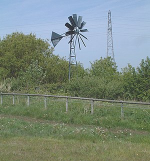 Renewable Energy and Fossil Fuel. A wind pump ...