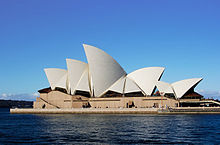 The Sydney Opera House appears to float on the harbour. It has numerous roof-sections which are shaped like huge shining white sails