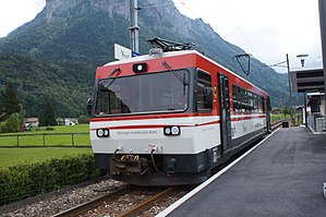 Red-and-white train at side platform