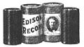 Two Edison cylinder records (left and right) and their cylindrical cardboard boxes (center)