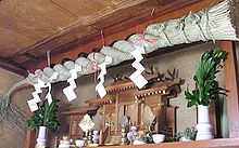 A Shinto Kamidana
(household altar) in Japan. Note the shimenawa
, a rope demarking the sanctuary area seen above, along the ceiling. Kamidana.jpg
