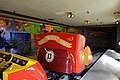 Ride vehicles departing the loading station.The loading station features a hand drawn paint of the Knott's Bear-y family journey to the fair