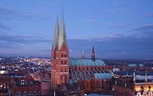 St. Mary's Church in Lubeck, Germany with red and varnished brick, edges of granite and cornices of limestone Marienkirche am Abend.jpg