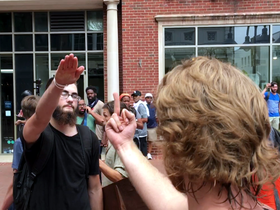 A far-right protestor gives the Nazi salute at the Unite the Right rally in Charlottesville during 2017. Nazi Salute (36543229556).png