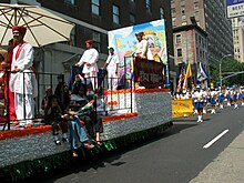 New York City's annual India Day Parade, the world's largest Indian Independence Day parade outside India, marches down Madison Avenue in Midtown Manhattan. The parade addresses controversial themes, including racism, sexism, corruption, and Bollywood. New York city India day parade August 2005.jpg