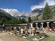 Old Church cemetery graves surrounded by the east wall of Monte Rosa, Macugnaga, Italy