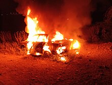 Palestinian car set on fire by Israeli settlers following the killing, Northern Jordan valley Palestinian car set on fire by Israeli settlers April 2024.jpg