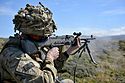 Pictured is a soldier of First Fusiliers operating a GPMG during a section level attack. MOD 45156947.jpg