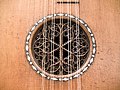 Baroque guitar soundhole with inserted wooden rose and inlaid rosette (1700).