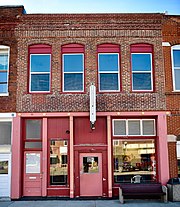 A red-colored storefront along a street in New Franklin, Missouri