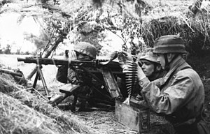 Two men in trench with gun