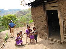 An indigenous family in a small mountain village in Honduras Honduras house copan.jpg