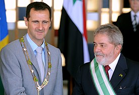 Bashar al-Assad wearing the "Grand Collar" of the National Order of the Southern Cross, accompanied by Brazilian President Luiz Inacio Lula da Silva in Brasilia, 30 June 2010 Lula Al-Assad Itamaraty 2010.jpg