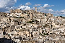 The Sassi cave houses of Matera are believed to be among the first human settlements in Italy, dating back to the Paleolithic. Matera from Piazzetta Pascoli-2930.jpg