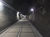 宜蘭線鐵路擴建工程完工後廢棄的單線「舊草嶺隧道 」（福隆站＝石城站間），2007年以自行車道之姿重新啟用（作者：lienyuan lee）。