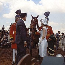 Mohammed Ayub Khan, the second president of Pakistan presenting Jackie Kennedy a gelding, 1962 Pakistan President Mohammed Ayub Khan presents Mrs. Kennedy with a bay gelding as a gift, March 22, 1962 (cropped).jpg