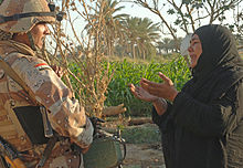 A woman pleads with an Iraqi army soldier from 2nd Company, 5th Brigade, 2nd Iraqi Army Division to let a suspected insurgent free during a raid near Tafaria, Iraq. Pleadingforfreedom.jpg