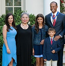 Woods after receiving the Presidential Medal of Freedom in 2019. From left to right: then girlfriend Erica Herman, mother Kultida Woods, daughter Sam Woods, son Charlie Woods, and Tiger Woods President Trump Presents the Medal of Freedom to Tiger Woods (47813420571) (cropped).jpg