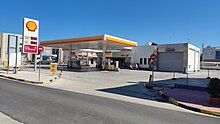 Filling station in Argos, Peloponnese owned by Shell. Shell and local subsidiaries own and operate thousands of filling stations worldwide. Shell filling station, Greece.jpg