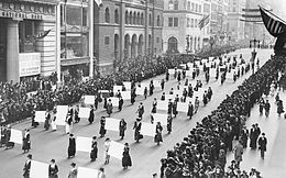 Women's suffragists parade in New York City in 1917, carrying placards with the signatures of more than a million women. Suffragists Parade Down Fifth Avenue, 1917.JPG