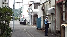 A Hokkaido Prefectural Police officer conducting a routine inspection in Ashibetsu. 2021-09-08 Hokkaido Prefectural Police officers in Ashibetsu city (Bei Hai Dao Jing Jing Cha Guan niyoruXun Hui Lian Luo )S0158477.jpg