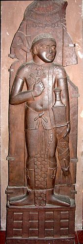 Indian relief of probable Indo-Greek king, with Buddhist triratana symbol on his sword. Bharhut, 2nd century BC. Indian Museum, Calcutta. Bharhut Yavana.jpg