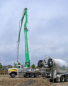 The back of the concrete mixer truck carries a 'booster axle', which can be lowered to extend the wheelbase of a fully loaded truck to comply with regulations. Concrete pumper truck, Denver.jpg