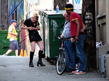 English: Three drug addicts seen smoking a hug...