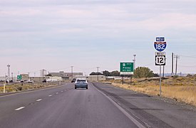 Photograph of a freeway with several highway shields on the side