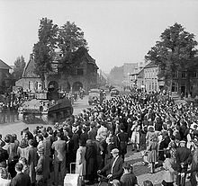 British Sherman tanks liberate Valkenswaard during Operation Market Garden, September 1944. Sherman tanks advancing through Valkenswaard.jpg