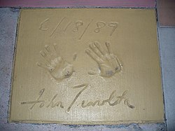 The handprints of John Travolta in front of The Great Movie Ride at Walt Disney World's Disney's Hollywood Studios theme park.